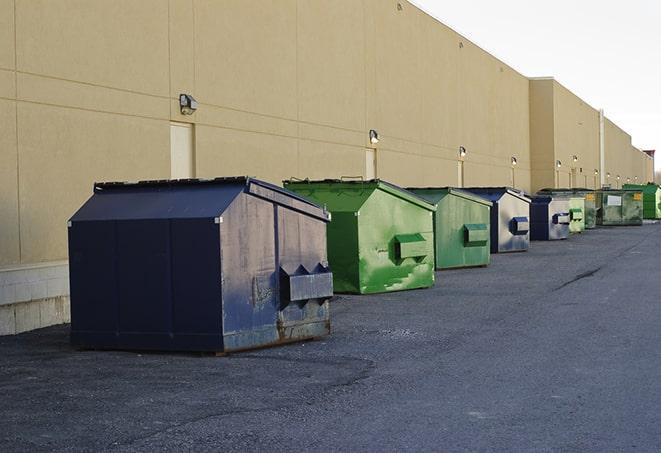 a yellow construction dumpster filled with waste materials in Hallandale Beach, FL